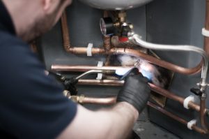 soldering on gas pipework by a student