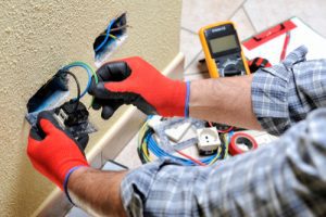 person wiring a plug