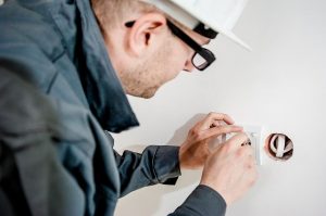 Electrician fixing a socket