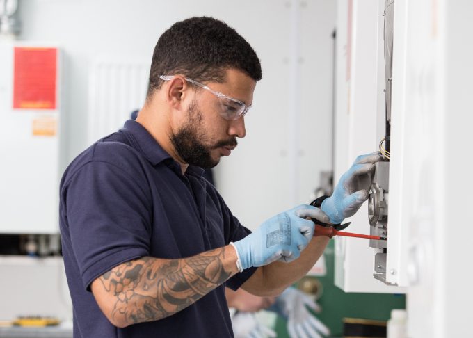 student working on a boiler