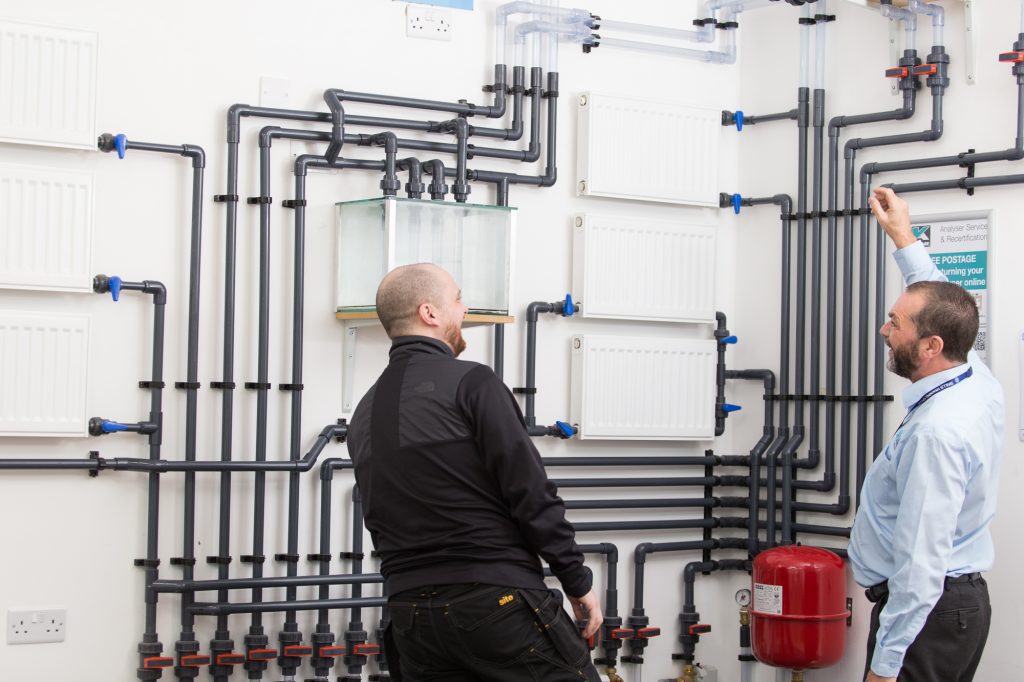 a student being taught on our plumbing course training rig