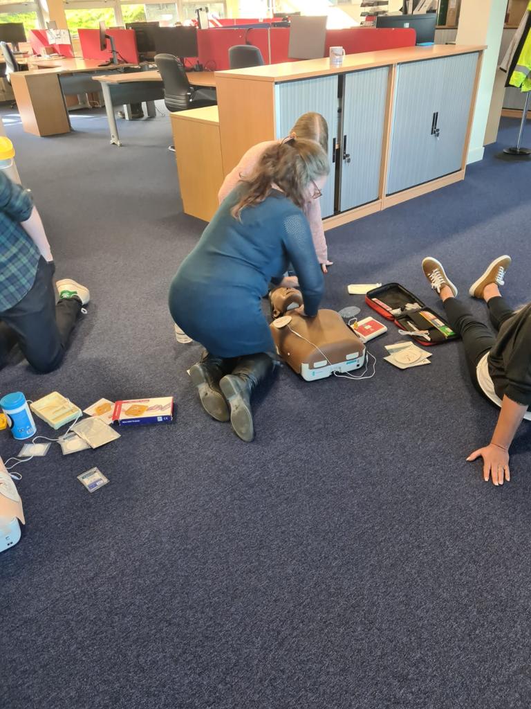 on-site training at a venue with first aiders being taught CPR