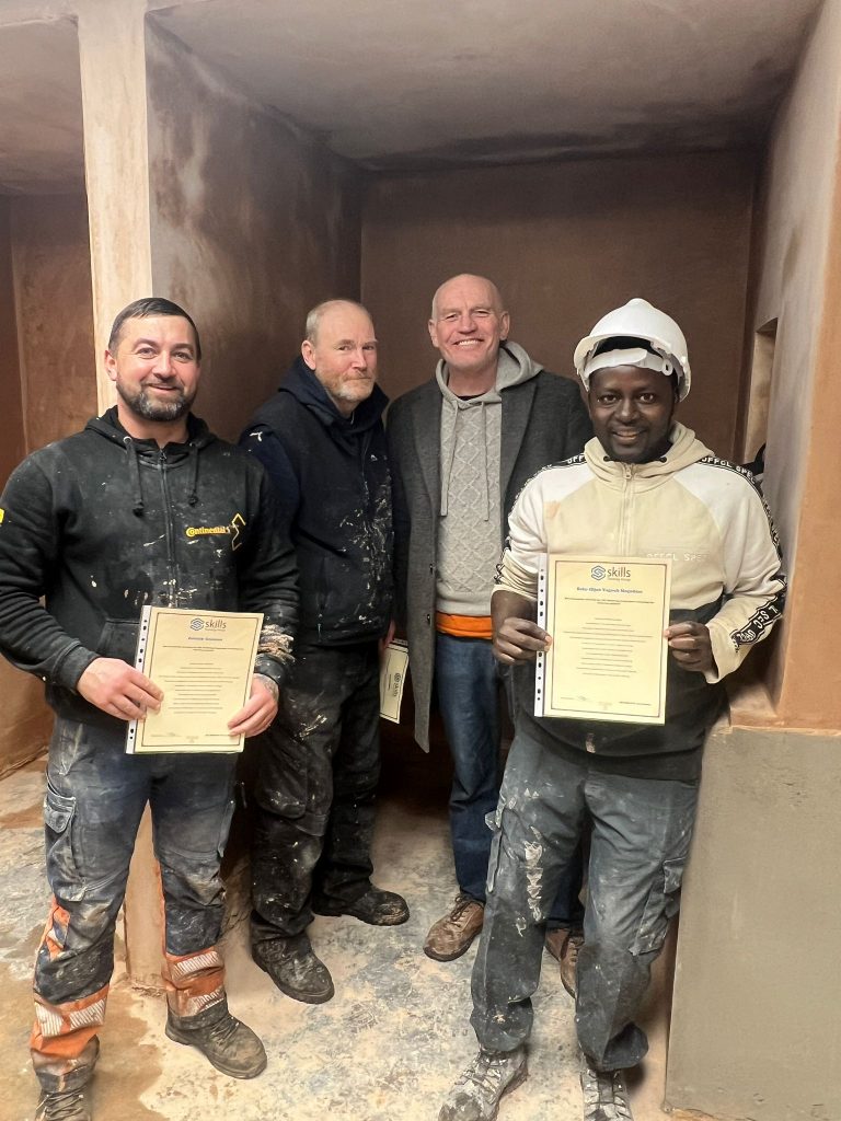 trainees with their plastering course certificates on their 5-day DIY course.