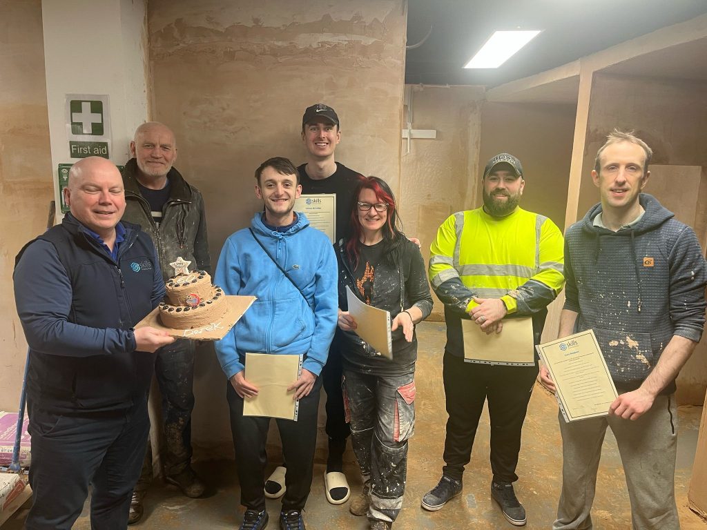 plastering trainees with Derek their trainer