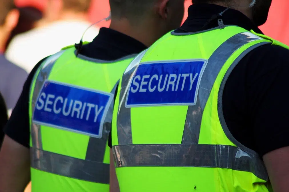 Two security officers wearing high-visibility security vests