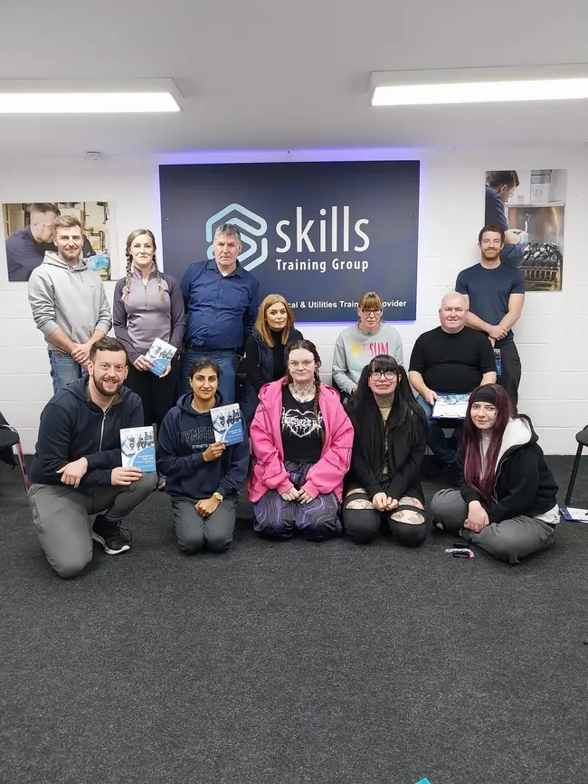 A group of first aid learners with their course manuals