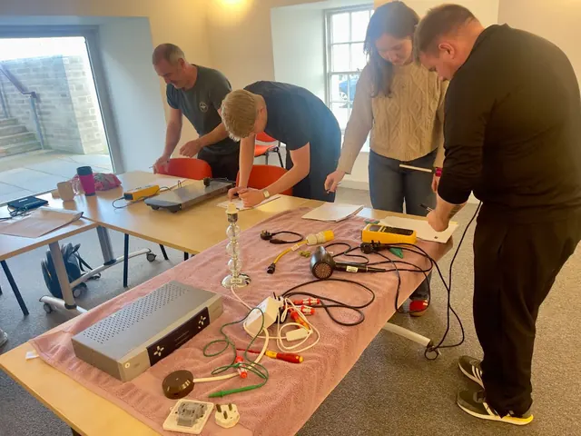 A small group practising inspection and testing around a training table