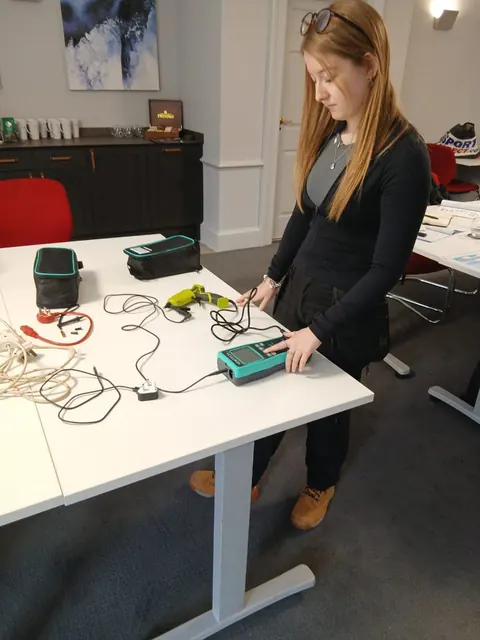 A learner using a PAT tester during practical training